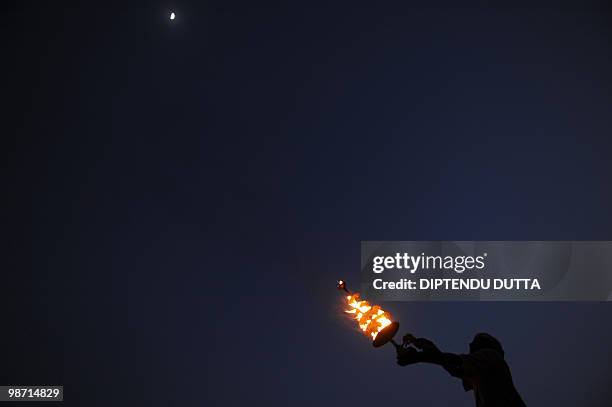 An Indian priest performs 'Aarti' at Sangam, the confluence of the Ganges, Yamuna and mythical Saraswati rivers in Allahabad on April 22, 2010....