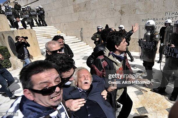 Protesters try to save Manolis Glezos , Greek left wing politician and writer, known especially for his participation in the World War II resistance,...