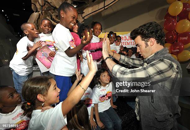Musician Kevin Jonas of the Jonas Brothers greets students from Manhattan Place Elementary School at the Natural History Museum on April 27, 2010 in...