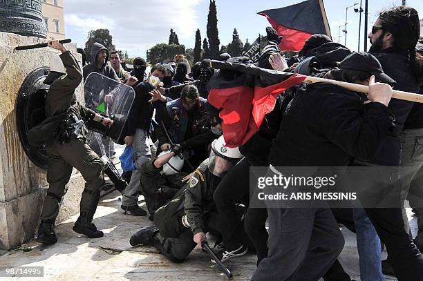 Demonstrators clash with riot police during a protest outside the Greek parliament in Athens on March 5, 2010. Greek police fired tear gas and...