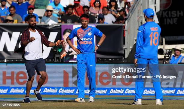 Spectator invades the pitch and runs towards Virat Kohli of India during the Second International Twenty20 Match at Malahide, Dublin.