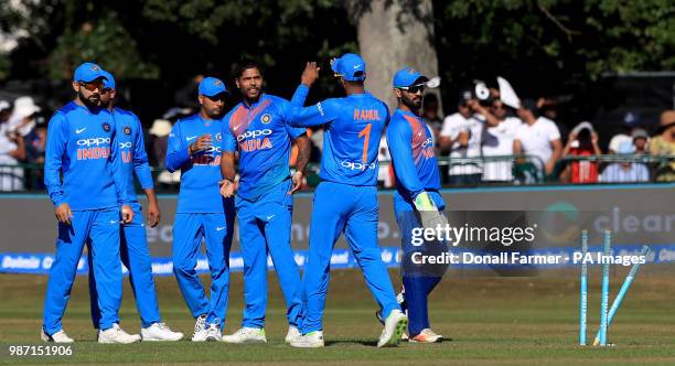 The India players celebrate taking their first wicket of the match during the Second International Twenty20 Match at Malahide, Dublin.