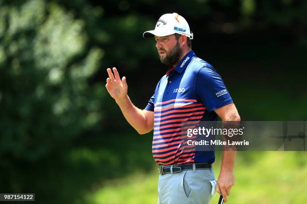 Marc Leishman of Australia reacts after putting on the ninth green during the second round of the Quicken Loans National at TPC Potomac on June 29,...