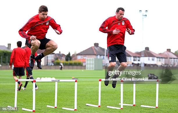 Steven Gerrard of Liverpool and team mate Jamie Carragher exercise during a training session prior to the UEFA Europa League semi final second leg...