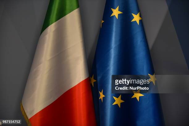 Italian and a Union Flag are pictured at The European Council summit in Brussels on June 28, 2018.he agenda includes discussion on migration,...