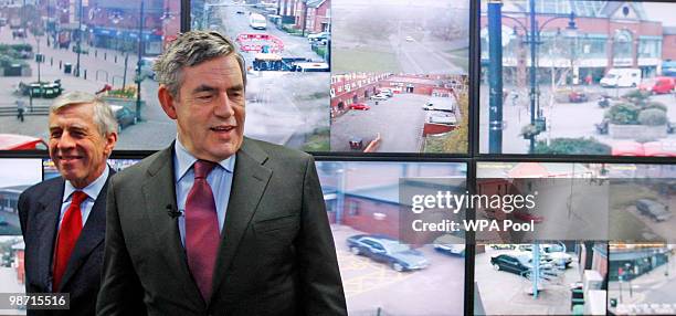 Prime Minister Gordon Brown and Justice Secretary Jack Straw talk to Police officers as they monitor screens from CCTV cameras in the Oldham event...