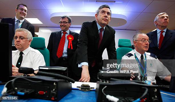 Prime Minister Gordon Brown and Justice Secretary Jack Straw talk to Police officers as they monitor screens from CCTV cameras in the Oldham event...