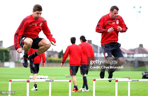 Steven Gerrard of Liverpool and team mate Jamie Carragher exercise during a training session prior to the UEFA Europa League semi final second leg...