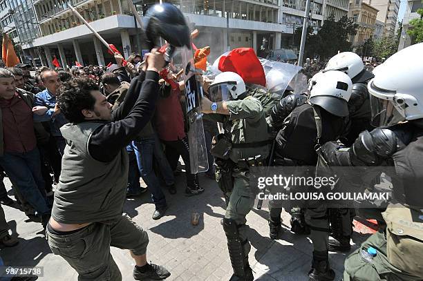 Demonstrators scuffle with riot police during a demonstration in central Athens on April 22, 2010. Greek civil servants today staged the fourth...