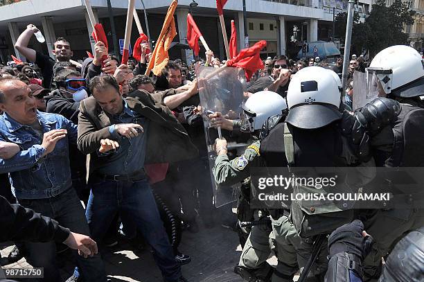 Demonstrators scuffle with riot police during a demonstration in central Athens on April 22, 2010. Greek civil servants staged on Thursday the fourth...