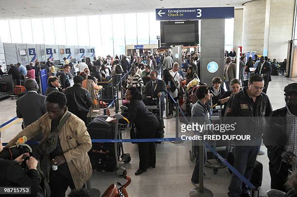 Passengers wait in line to check in at Roissy-Charles-de-Gaulle airport on April 21, 2010 in Roissy-en-France, northern Paris. All long-haul...