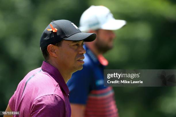 Marc Leishman of Australia and Tiger Woods look on after completing their round on the 9th green during the second round of the Quicken Loans...