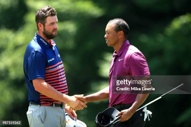 Marc Leishman of Australia and Tiger Woods shake hands after completing their round on the 9th green during the second round of the Quicken Loans...