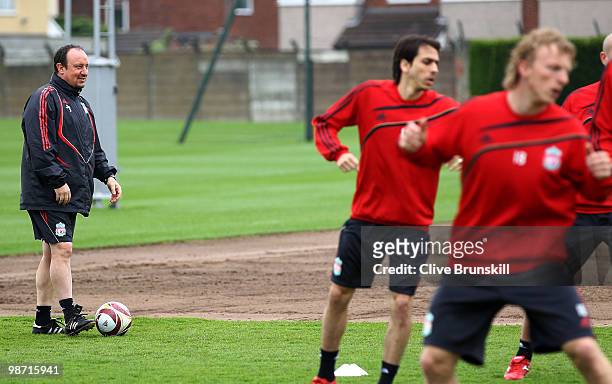 Liverpool manager Rafael Benitez watches Dirk Kuyt and Yossi Benayoun in action during a training session prior to the UEFA Europa League semi final...