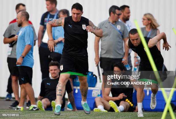 Uruguay's midfielder Cristian Rodriguez and Uruguay's defender Diego Laxalt take part in a training session of Uruguay's national football team at...