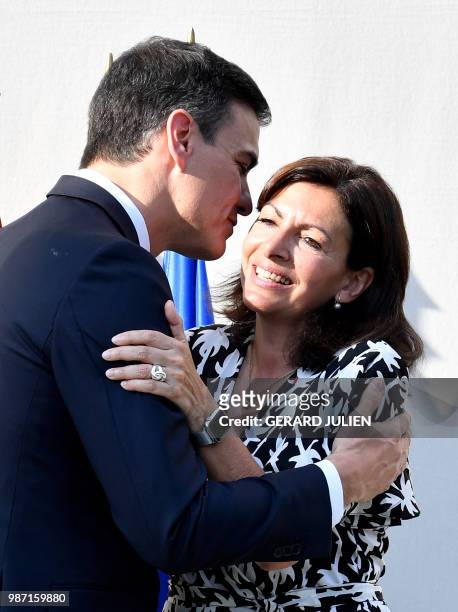 Spain's Prime Minister Pedro Sanchez kisses Mayor of Paris Anne Hidalgo at the end of the speech at The Jardin de la Nueve in Hotel de Ville in Paris...