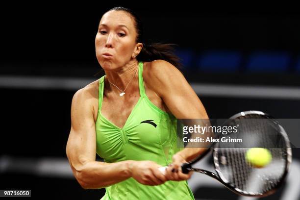Jelena Jankovic of Serbia plays a backhand during her first round match against Gisela Dulko of Argentina at day three of the WTA Porsche Tennis...