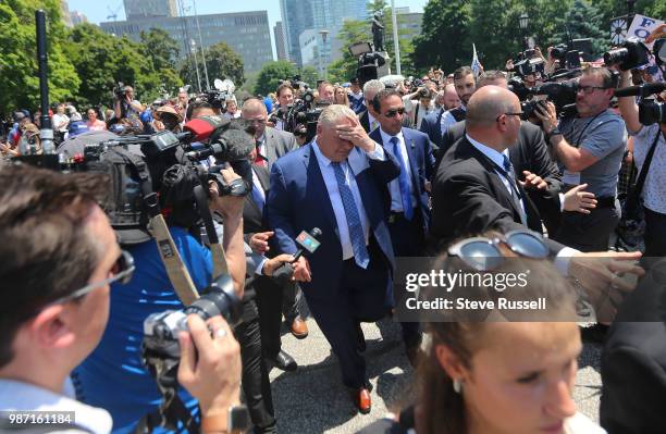 Doug Ford greets supporters after making a speech as he performs a ceremonial swearing in outside. Doug Ford is sworn in as the 26th Premier of...