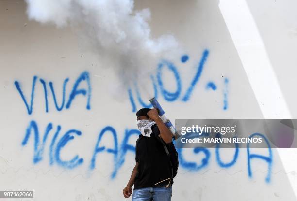 An anti-government demonstrator fires a home-made mortar during a protest demanding Nicaraguan President Daniel Ortega's resignation and justice for...