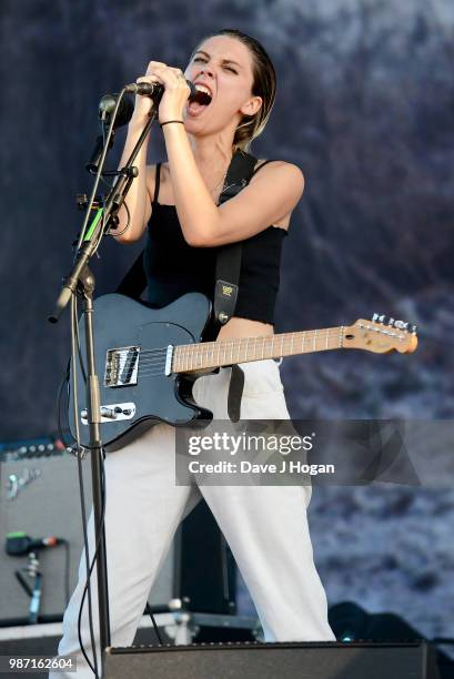 Ellie Rowsell of Wolf Alice supports Liam Gallagher on stage at Finsbury Park on June 29, 2018 in London, England.