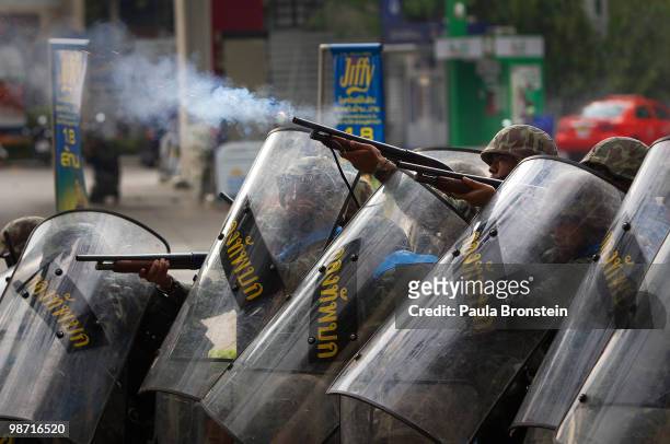 Members of the Thai military shoot at red shirt protesters during a gun battle as violence flares outside the city on April 28, 2010 in Bangkok,...