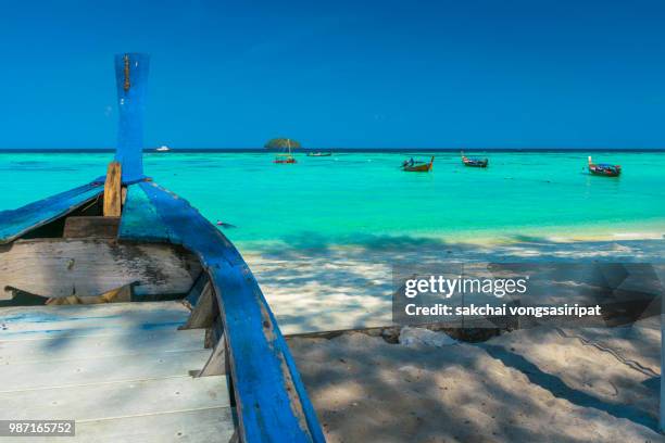 scenic view longtail boats moored on beach and sea against sky at koh lipe, thailand - ko lipe stock pictures, royalty-free photos & images