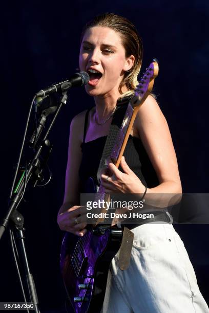 Ellie Rowsell of Wolf Alice supports Liam Gallagher on stage at Finsbury Park on June 29, 2018 in London, England.