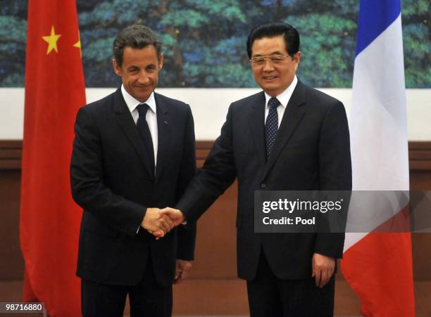 France's President Nicolas Sarkozy shakes hands with China's President Hu Jintao after a press conference at the Great Hall of the People on April...