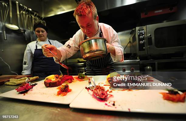 Icelandic chef Eythor Halldorsson prepares a plate made of traditional Icelandic produce, mink whale, horse, lamb, herrings and gravlax at...