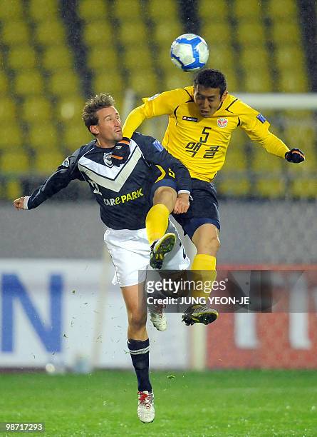 Cho Byung-Kuk of South Korea's Seongnam Ilhwa FC and Nick Ward of Australia's Melbourne Victory jump for the ball during a Group E football match of...