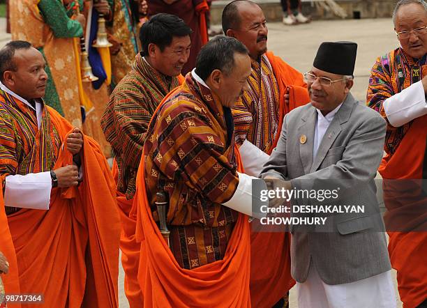 Bhutanese Prime Minister Jigmi Yoser Thinley greets Nepalese Prime Minister Madhav Kumar Nepal on his arrival to attend the 16th South Asian...