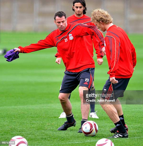 Jamie Carragher competes with Dirk Kuyt of Liverpool during a training session prior to their UEFA Europa League semi-final, second leg match against...