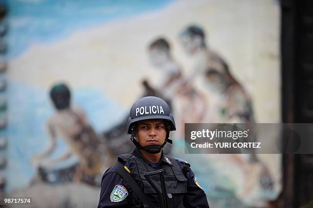 Policeman is seen nearby besieged Brazilian embassy in Tegucigalpa on September 29, 2009. Honduran de facto leaders pledged to reconsider a clampdown...