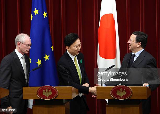 Yukio Hatoyama, Japan's prime minister, center, shakes hands with Jose Manuel Barroso, president of the European Commission, right, as Herman Van...