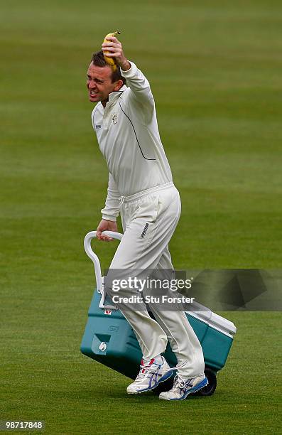 Hampshire 12th man Dominic Cork brings on the drinks during day two of the LV County Championship division one match between Warwickshire and...