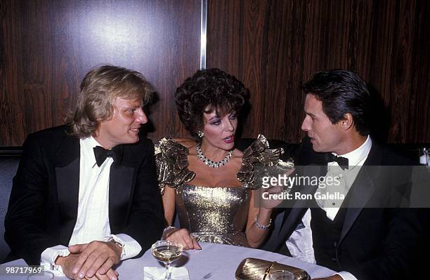 Actress Joan Collins, boyfriend Peter Holm and actor Michael Nader attend the 1983 Carousel of Hope Ball to Benefit the Barbara Davis Center for...