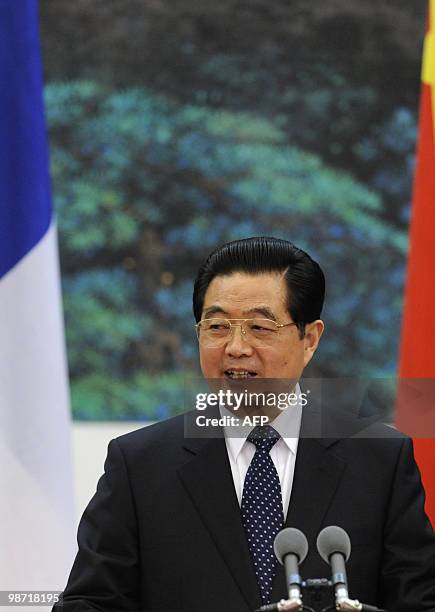 China's President Hu Jintao attends a press conference with French President Nicolas Sarkozy at the Great Hall of the People in Beijing on April 28,...