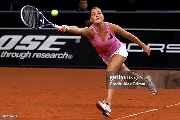 Agnieszka Radwanska of Poland plays a forehand during her second round match against Shahar Peer of Israel at day three of the WTA Porsche Tennis...