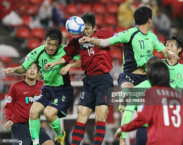 Japan's Kashima Antlers defender Lee Jung Soo fights for the ball with players of South Korea's Jeonbuk Motors during their group F match of the AFC...