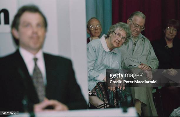 Woman peers at Labour Leader of the Opposition Tony Blair, at a campaign meeting in Tamworth, Staffordshire, 9th April 1996. Blair is campaigning for...
