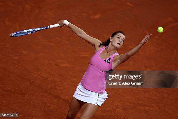 Agnieszka Radwanska of Poland serves the ball during her second round match against Shahar Peer of Israel at day three of the WTA Porsche Tennis...