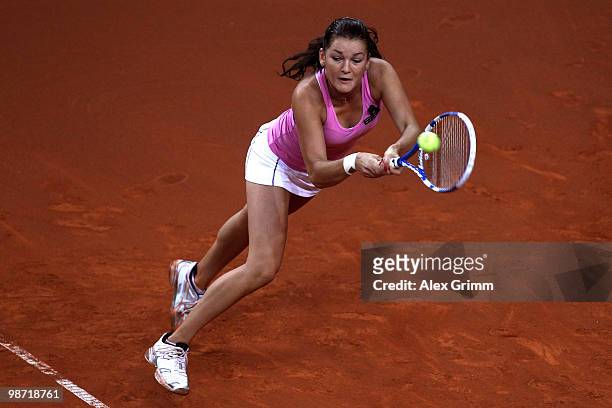 Agnieszka Radwanska of Poland plays a backhand during her second round match against Shahar Peer of Israel at day three of the WTA Porsche Tennis...