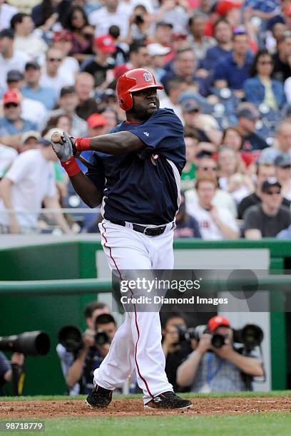 Infielder Cristian Guzman of the Washington Nationals swings at a pitch during the bottom of the sixth inning of an exhibition game on April 3, 2010...