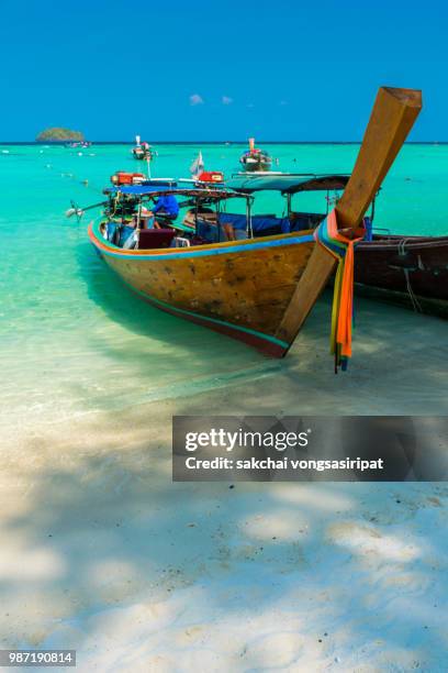 longtail boat moored on beach against sky at koh lipe, thailand - ko lipe stock pictures, royalty-free photos & images