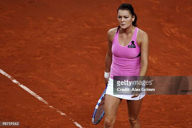 Agnieszka Radwanska of Poland reacts during her second round match against Shahar Peer of Israel at day three of the WTA Porsche Tennis Grand Prix...