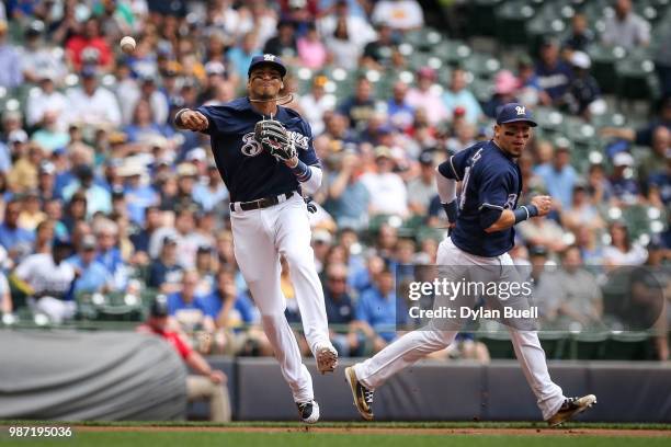 Orlando Arcia of the Milwaukee Brewers throws to first base as Hernan Perez looks on in the first inning against the Kansas City Royals at Miller...