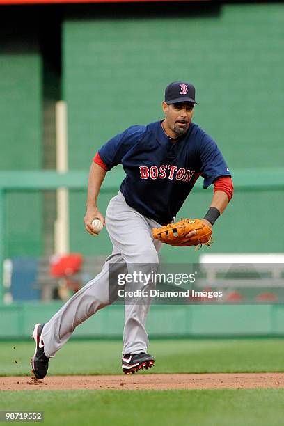 Firstbaseman Mike Lowell of the Boston Red Sox jogs to firstbase after fielding a ground ball to retire Willie Harris of the Washington Nationals...