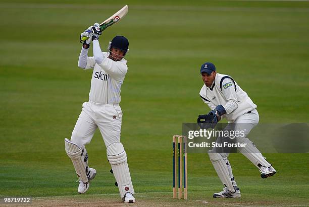 Warwickshire batsman Neil Carter cuts a ball to the boundary watched by Hampshire wicketkeeper Nic Pothas during day two of the LV County...