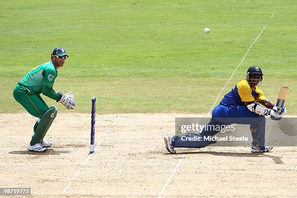 Sanath Jayasuriya of Sri Lanka sweeps a delivery as Mark Boucher looks on during The ICC T20 World Cup warm up match between Sri Lanka and South...