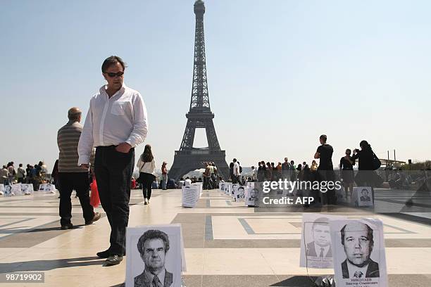 Man looks at pictures of Chernobyl's victims shown on April 24, 2010 on the Trocadero esplanade in front of the Eiffel tower in Paris, as part of a...